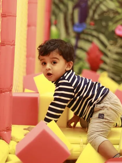 A curious toddler explores the soft blocks in our foam pit. This area is perfect for crawlers and early walkers to build confidence.