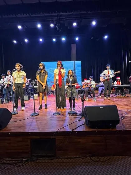 The stage is yours at Urban Raga. Our students are seen here performing as a vocal group with a live band during one of our recitals, building their confidence and teamwork skills in a real-world concert setting.