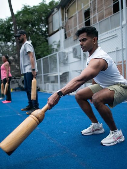 A participant demonstrates a perfect squat with a Mudgar during the L1 certification. The program emphasizes mastering foundational movements to build a strong base for more advanced techniques.