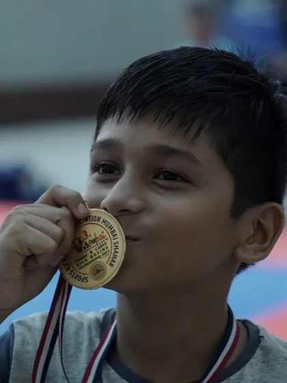 The sweet taste of victory. A young champion kisses his gold medal after the Junior Kick Boxing Mumbai District Tournament, a moment he will never forget.