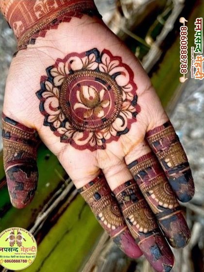 A close-up of a beautiful mandala design with a lotus at its center. The rich, dark color shows the quality of our organic henna paste.