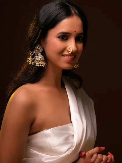 A gentle and serene portrait, with the model smiling. This adds a warm and approachable feel to the artistic series.