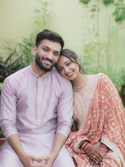 A relaxed and happy portrait of a couple during their engagement festivities. Their comfortable pose and genuine smiles show the deep friendship at the heart of their relationship.