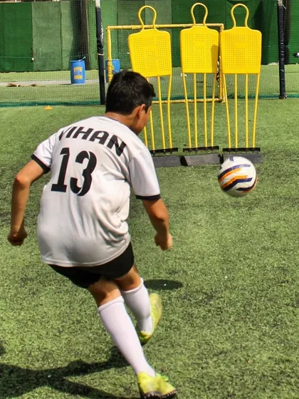 A player practices a free-kick against training mannequins, honing his technique and precision for critical set-piece situations.