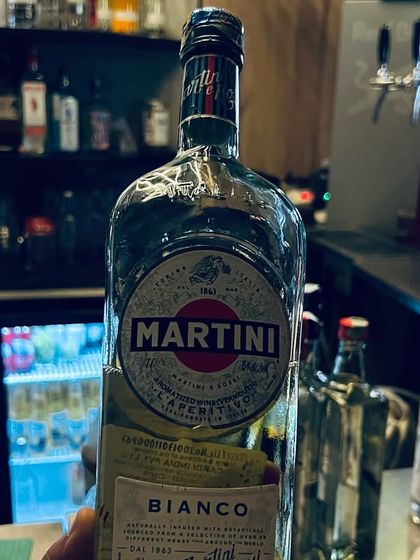 A bottle of Martini Bianco, ready to be mixed into your favorite classic cocktail by our skilled bartenders.