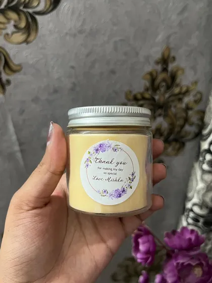 A custom birthday return favor candle. We can create custom stickers and colors to match your party theme.