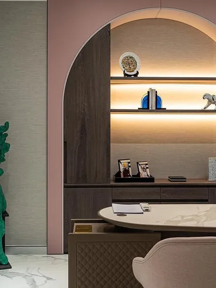 Another detail of the executive office, highlighting the arched shelving with integrated lighting. This feature provides a beautiful backdrop for personal artifacts and awards, adding a layer of personal storytelling to the professional space.
