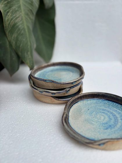 A stack of Rutile spoon rests, with one in the foreground showing off the beautiful glaze pattern.