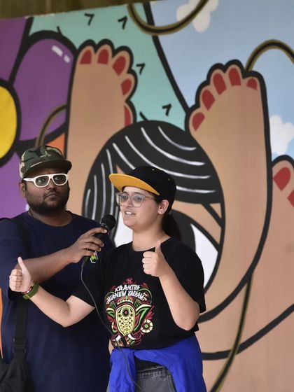Our founder and a Deaf community leader share the stage, giving a thumbs up. This represents the collaborative spirit that drives our inclusion initiatives.