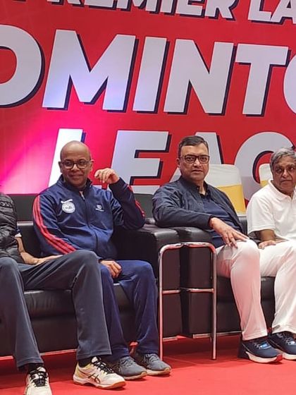 Esteemed colleagues and judges watching the matches at the badminton tournament.