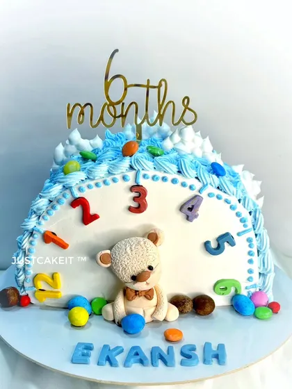 A half-cake to celebrate a 6-month-old baby boy. The clock face design is a creative way to mark the half-year milestone.