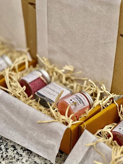 Another view of our hamper assembly line, showing how we carefully arrange products to create a visually appealing and well-balanced gift box.