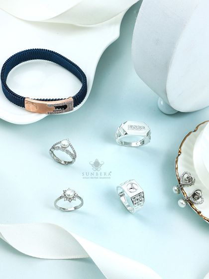 Shimmer in silver with this diverse collection. It includes a men's mesh bracelet, pearl rings, and statement earrings, demonstrating the breadth of our design capabilities.