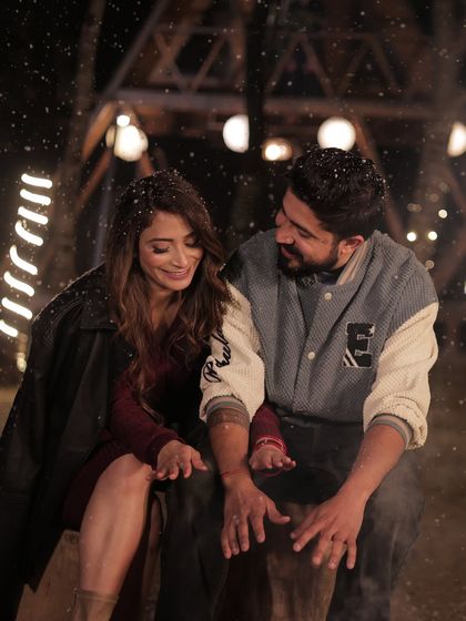 A candid, romantic moment from a pre-wedding shoot. The makeup is designed to look beautiful and natural even in close-up, intimate shots, with a focus on glowing skin.