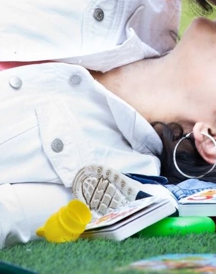 A creative, close-up shot of a mother and her baby sharing a kiss, with toys scattered around them. This captures the playful reality of life with a toddler.