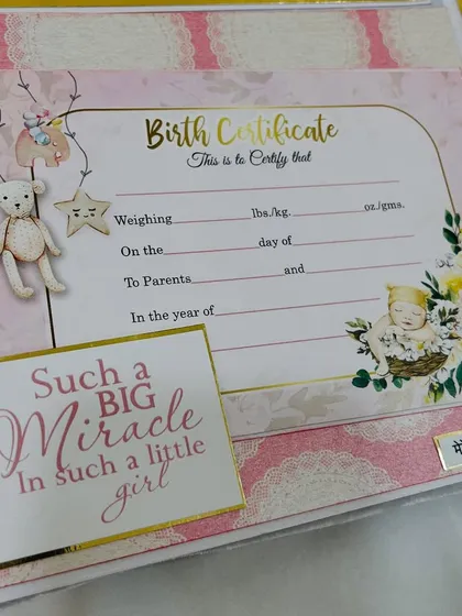 A customizable birth certificate page within the album, a beautiful way to record the most important details.