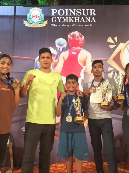 A group of our young medalists with their coach. We are building a legacy of champions from the ground up.