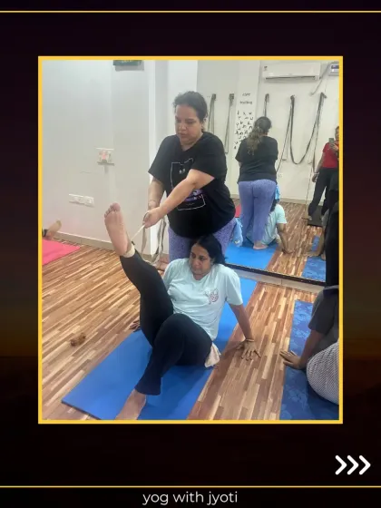 Yoga with a little help from my friends. Here, I am assisting a student to deepen her leg stretch, showing how partner work can enhance flexibility.