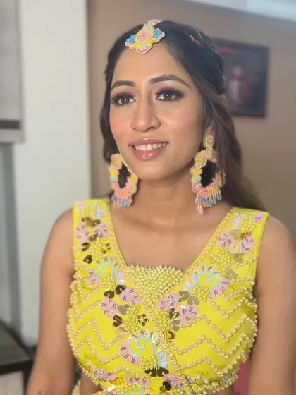 A close-up of the Haldi bride's makeup, showing the fun pink winged liner.