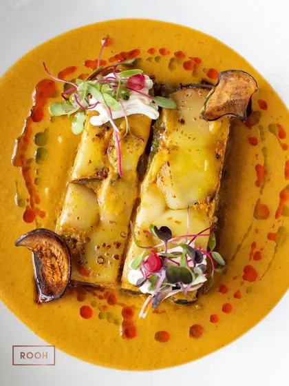 My modern take on Baingan Bharta, presented as a refined terrine. Layers of smoky eggplant are complemented by a rich, creamy sauce and garnished with microgreens.