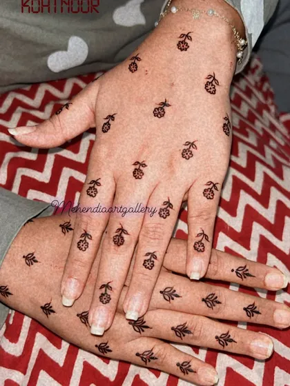 A lovely pattern of scattered small floral and leaf motifs on the back of the hands. This creates a delicate, sprinkled effect.