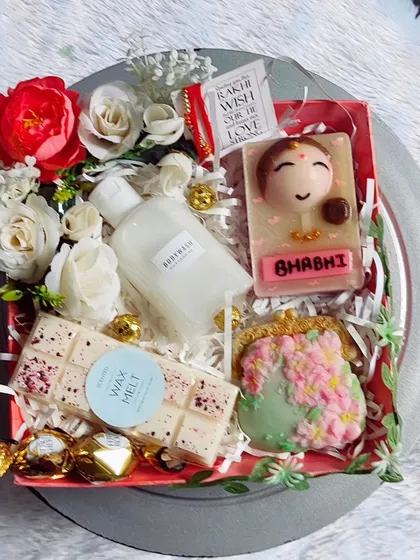 A beautiful Rakhi hamper for a sister or bhabhi, featuring a purse soap, a cameo soap, wax melts, and a rakhi.