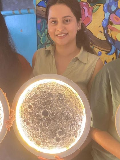 The glittery smiles say it all. A participant from our first 3-D Moon workshop proudly holds up her beautifully crafted, glowing moon lamp.