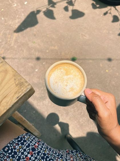 Enjoying a perfectly frothed coffee in the morning sun. The simple pleasures are often the best.