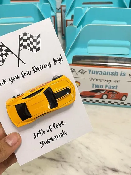 It's all in the details. For a "Two Fast" themed second birthday, we created these custom "Thank you for Racing By" return favours, complete with a toy car for each little guest.