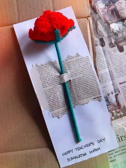 A single crochet rose attached to a custom "Happy Teacher's Day" card.