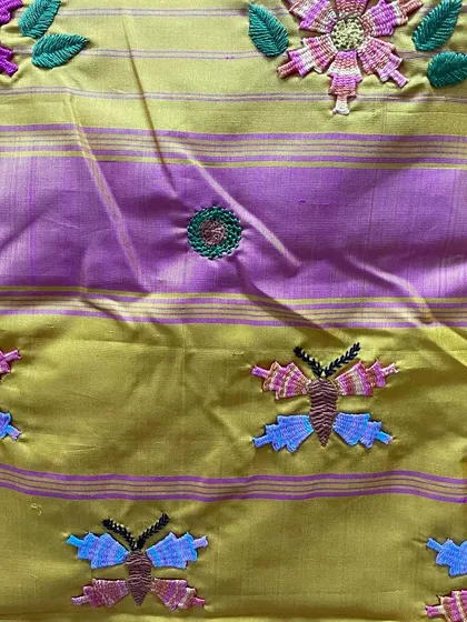 This image highlights the interplay between the woven zari of the Kanjeevaram and the hand-stitched Kamal Kadai butterflies. It's a beautiful fusion of two distinct textile arts.