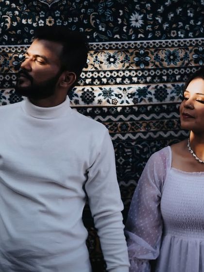 A beautifully lit portrait against a textured backdrop. The play of light and shadow adds depth and a cinematic quality to the image.