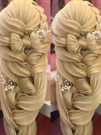 A close-up of the open hairstyle with multiple bow details and pearl accessories.