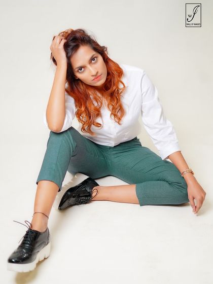 A more relaxed, thoughtful pose from the same series, showing versatility and a different mood.