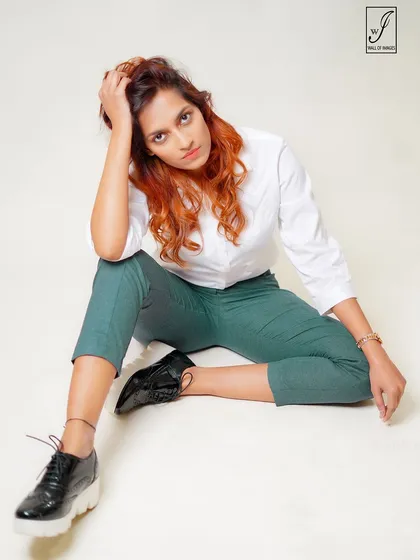 A more relaxed, thoughtful pose from the same series, showing versatility and a different mood.