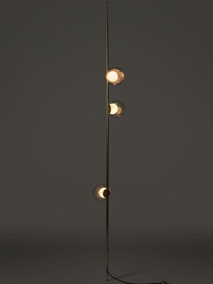 A full-length studio shot of a vertical Bocci stem, highlighting its sleek form and the arrangement of the glass pendants.