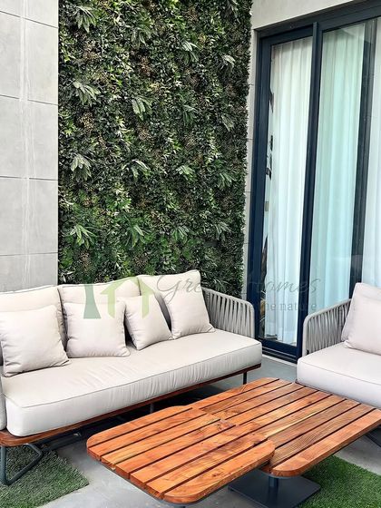 A detailed view of the faux vertical garden wall on the balcony. These green walls are a fantastic, low-maintenance way to add a significant amount of greenery to a small space.