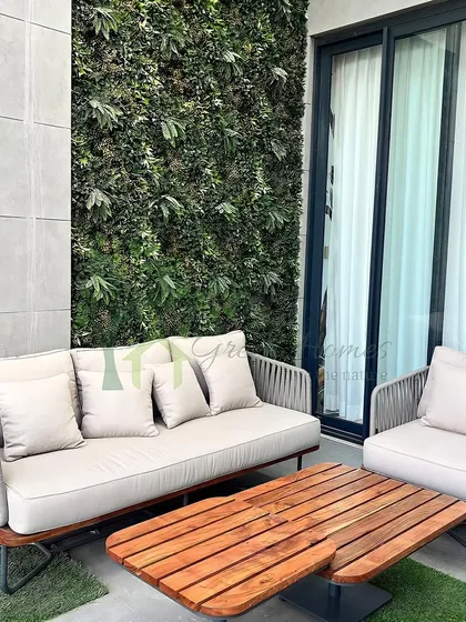 A detailed view of the faux vertical garden wall on the balcony. These green walls are a fantastic, low-maintenance way to add a significant amount of greenery to a small space.