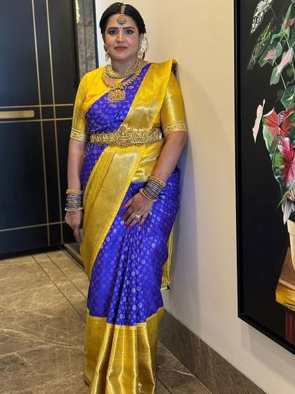 Priya's full look, complete with a traditional gold vaddanam (waist belt), is the epitome of South Indian elegance.