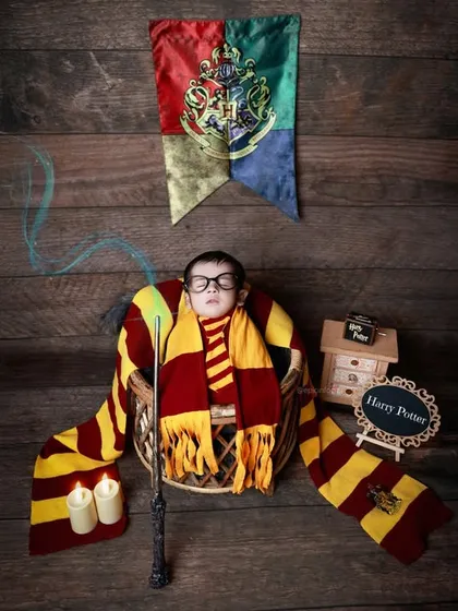 Our magical Harry Potter theme, complete with a Gryffindor scarf and wand. We specialize in bringing your imaginative ideas to life with detailed props and creative setups for a truly unique newborn photoshoot.