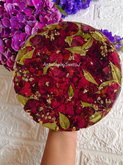 A full, lush coaster made entirely of preserved red rose petals and leaves, with flecks of gold leaf for a touch of sparkle. This is a great way to preserve a bouquet in a functional piece.