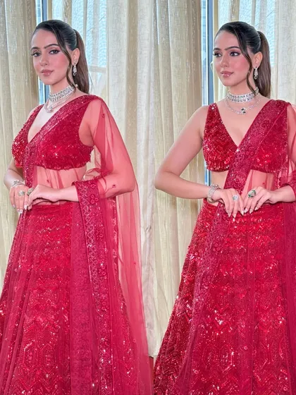 A full-length view of the red cocktail lehenga. The look is bold, confident, and perfect for a bride who wants to shine.