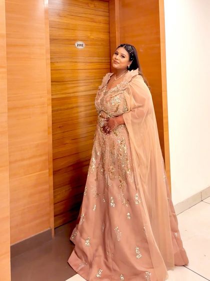 The full look of the peach plus-size gown with its elegant cape. It's a perfect choice for a reception or engagement.