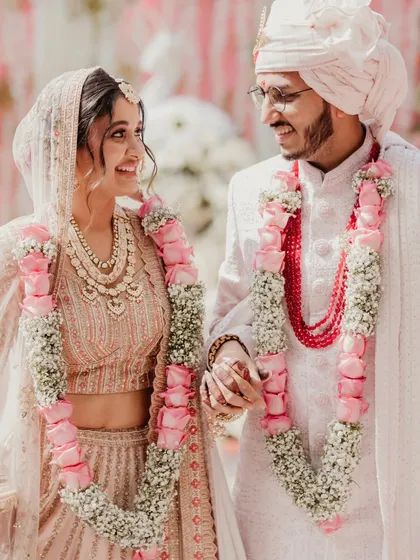 That just-married glow. This candid shot after the varmala is full of smiles and happiness, capturing the pure joy of starting your forever.