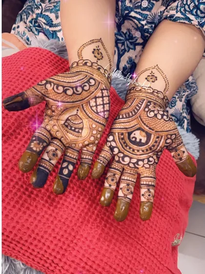 Another view of the 'kalash' and elephant design, showing the fresh henna paste.