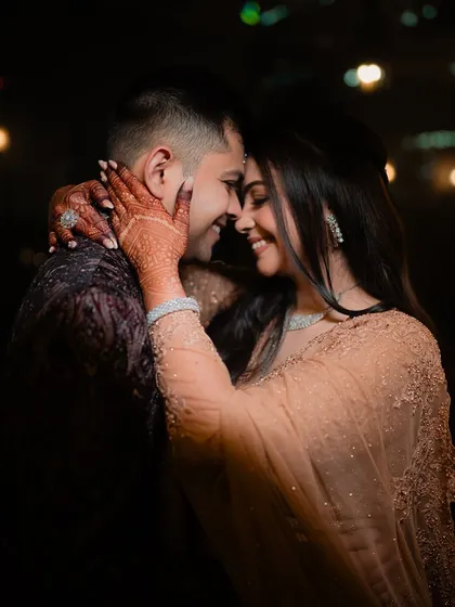 Amidst the energy of the Sangeet, we find the quiet moments of connection. This intimate portrait showcases the couple's bond, a calm and loving glance that speaks volumes.