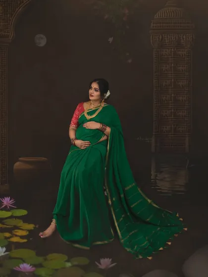A candid, thoughtful pose that brings a natural feel to the painterly setup. The mother-to-be's gentle expression and the soft lighting combine to create a portrait that is both artistic and deeply personal.