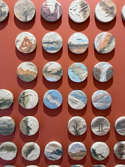 A close-up of some of the 100 little landscapes. Each one is a unique, tiny work of art, creating an incredible amount of detail for the viewer to discover.
