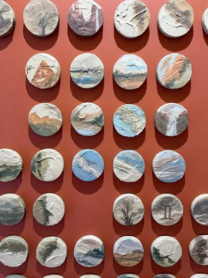 A close-up of some of the 100 little landscapes. Each one is a unique, tiny work of art, creating an incredible amount of detail for the viewer to discover.