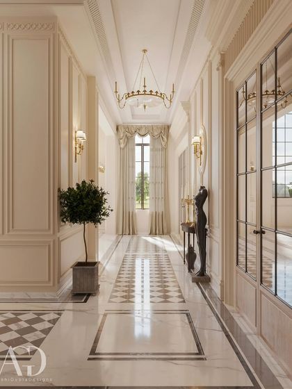 A view down a classically designed hallway, where symmetry and proportion are paramount. The intricate marble flooring, paneled walls, and elegant chandelier at the end of the vista create a perspective that is both harmonious and visually compelling.